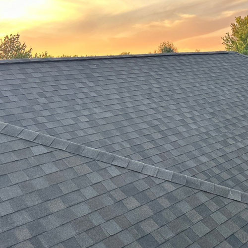 Red brick home with light shingled roof